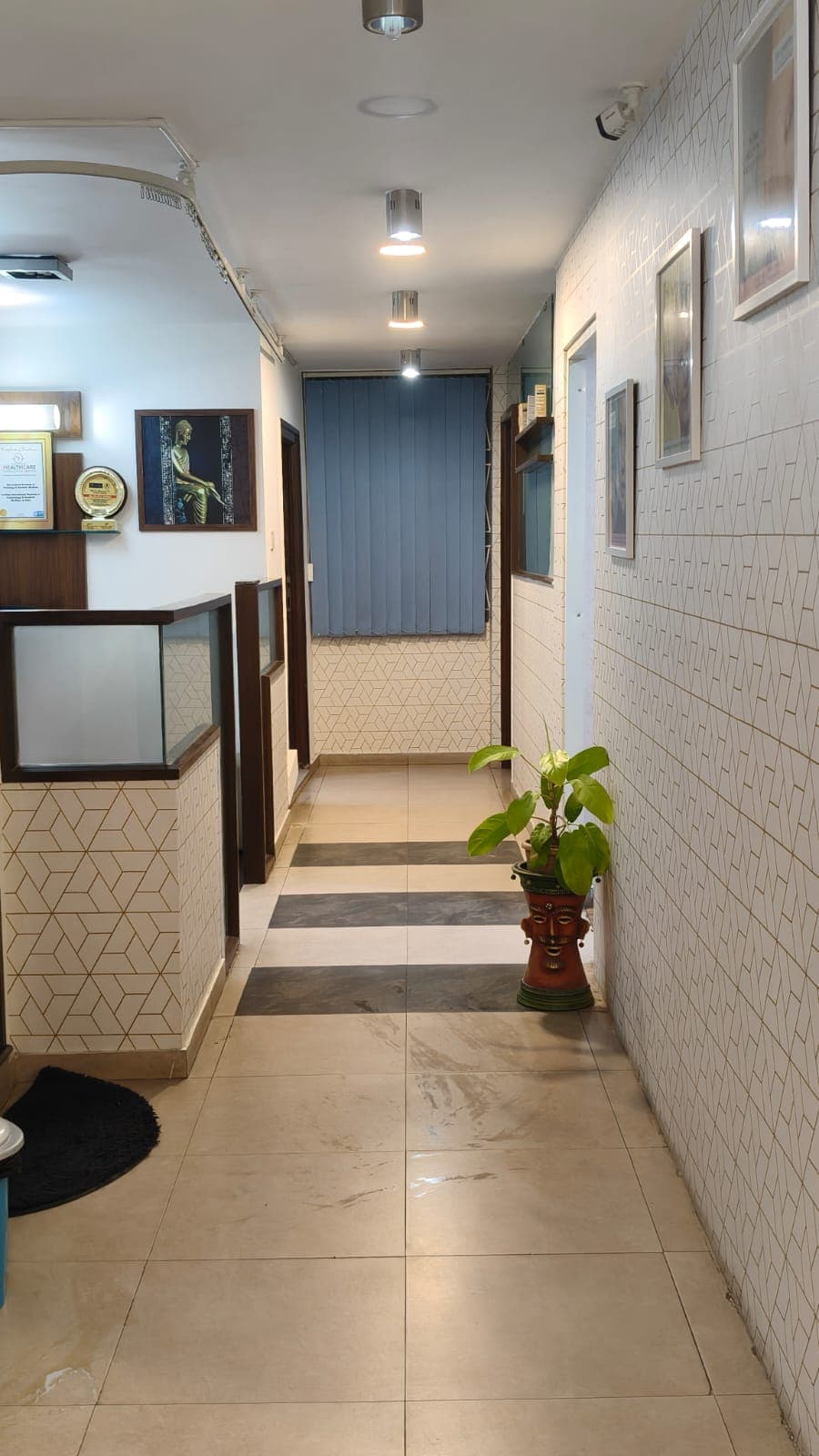 Elegantly styled clinic corridor with gold geometric design and natural lighting
