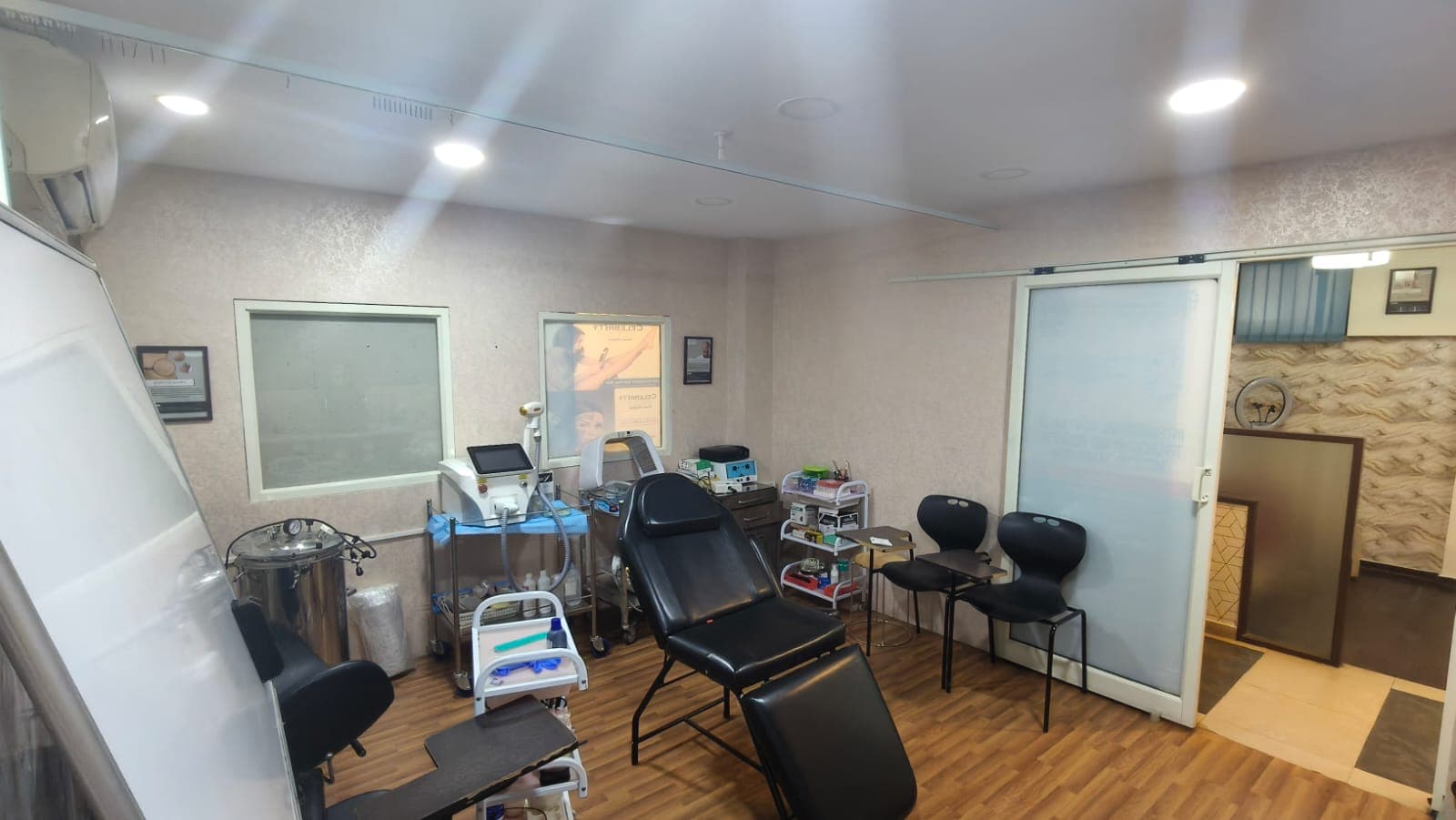 High-tech cosmetic treatment room with modern medical equipment and seating